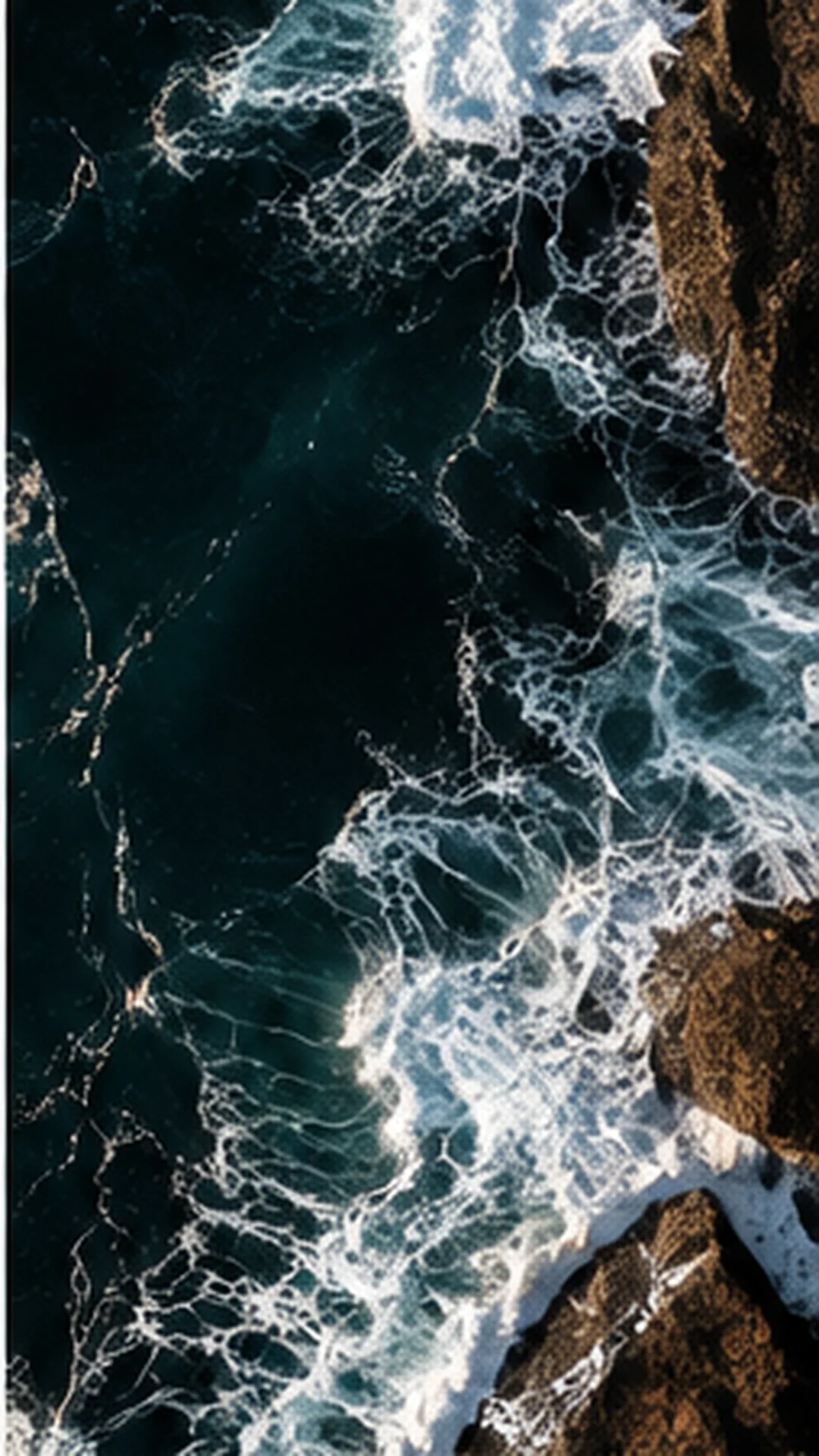 Ocean waves moving around coastal rock formations